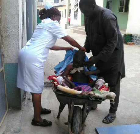 Man Takes Son To Hospital In Wheelbarrow In Imo State After Waiting Hours But No Available Vehicle [Photos]