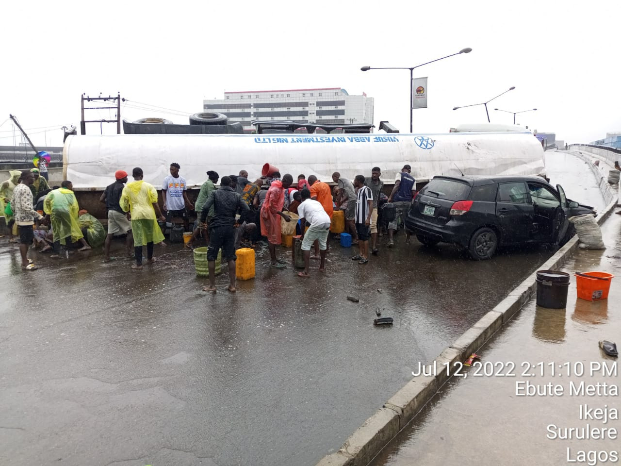 Loaded tanker falls at Costain, crushing car and spilling its content on the road (video)