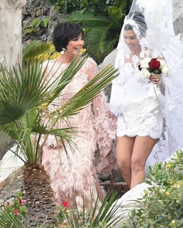 Kourtney Kardashian stuns in a mini dress and a veil with an embroidery of the Virgin Mary as she marries Travis Barker again