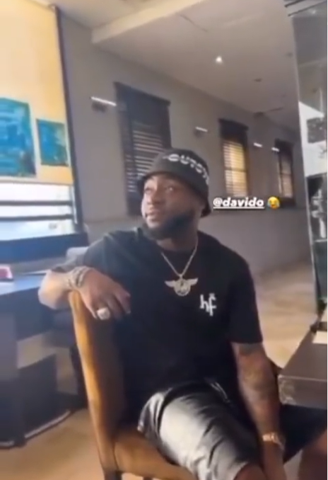 Between Davido and a fan singing for him
