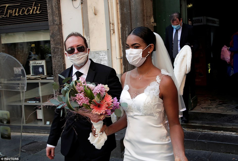 Coronavirus: Newlyweds kiss in Italy through protective masks at their wedding (Photos)