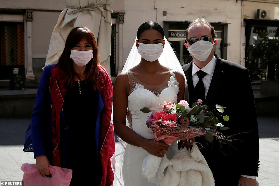 Coronavirus: Newlyweds kiss in Italy through protective masks at their wedding (Photos)