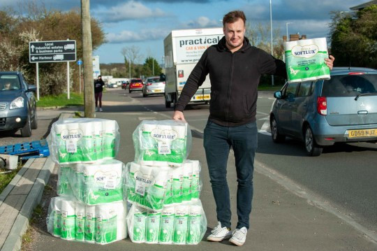 DJ cashes in on coronavirus pandemic as he makes �3,000 in two hours selling toilet roll out of the back of his van (photos).