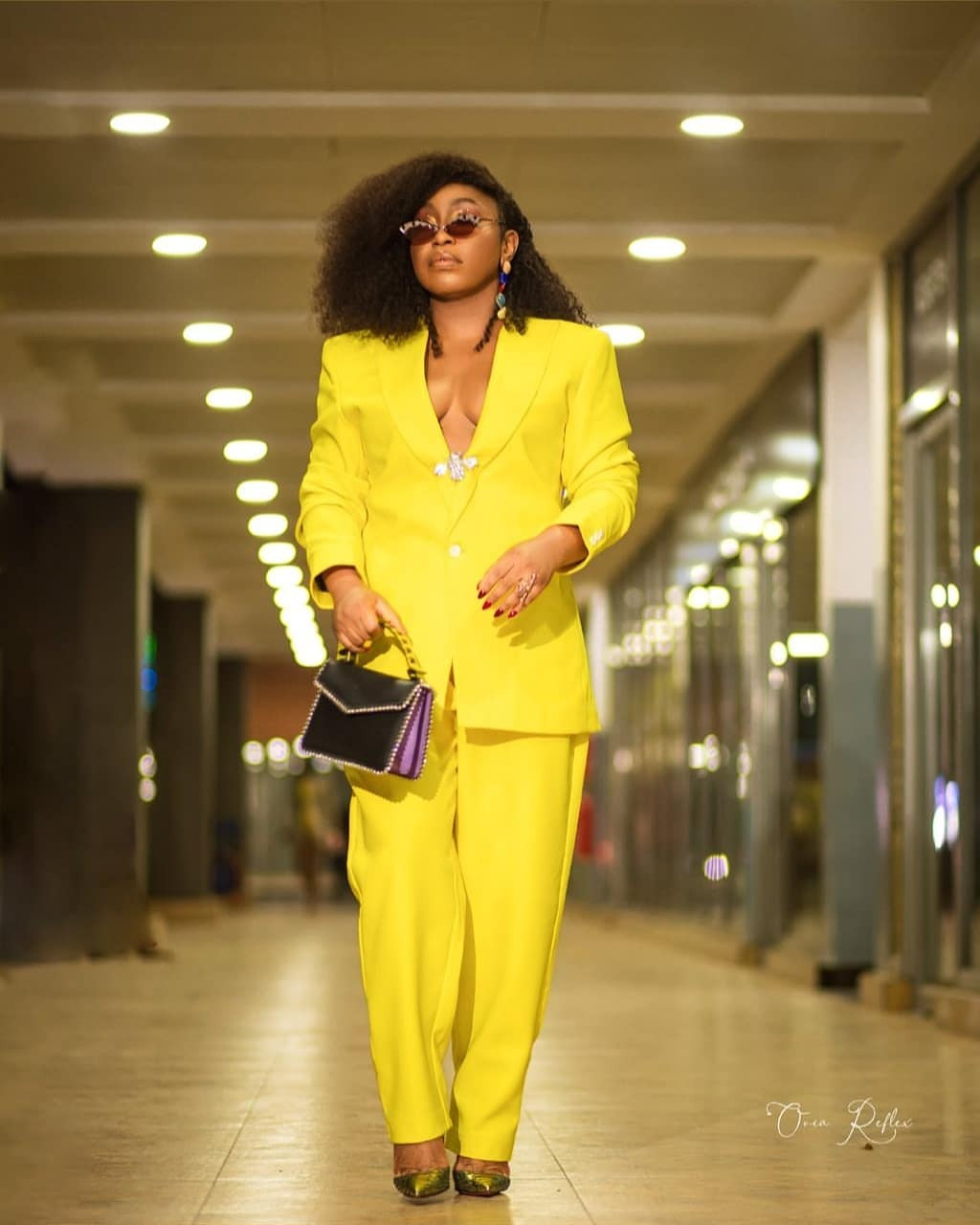 Rita Dominic flashes her cleavage in a yellow 2-piece pant suit (photos)