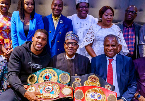 Anthony Joshua prostrates as he presents his World Heavy Championship belts to President Buhari in London (Photos)
