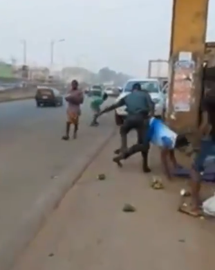 Anambra task force officials seen dragging trader on the floor and pulling out daggers (video)