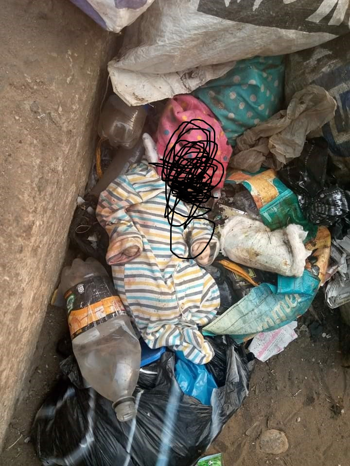 Body of fully clothed newborn baby found in refuse dump at a bus stop in Lagos (graphic photos)