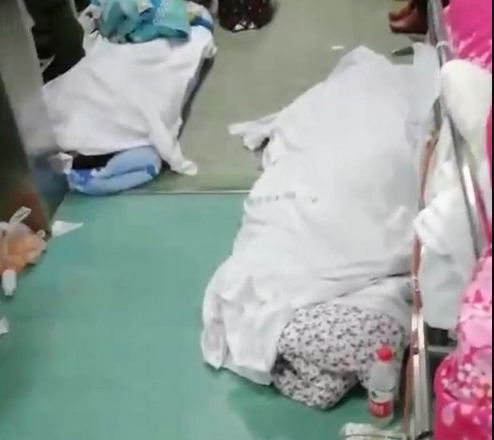 Coronavirus: Nurses step over dead bodies piled up on hospital floor as medical facilities are overrun by outbreak (disturbing video)