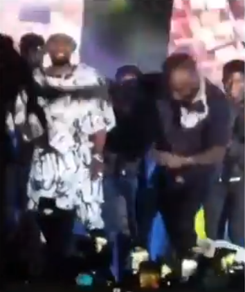 Moment Davido dodged a fan who jumped on stage to hug him (video)