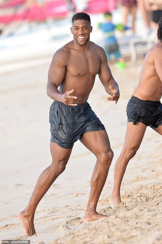 Anthony Joshua shows off his muscular physique during beach day in Barbados (Photos)