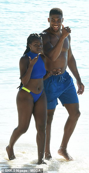 Shirtless Anthony Joshua pictured with a female companion at the beach in Barbados (Photos)