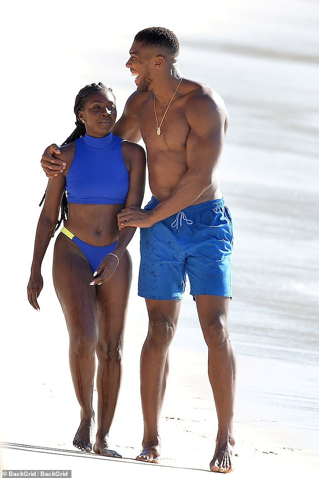Shirtless Anthony Joshua pictured with a female companion at the beach in Barbados (Photos)