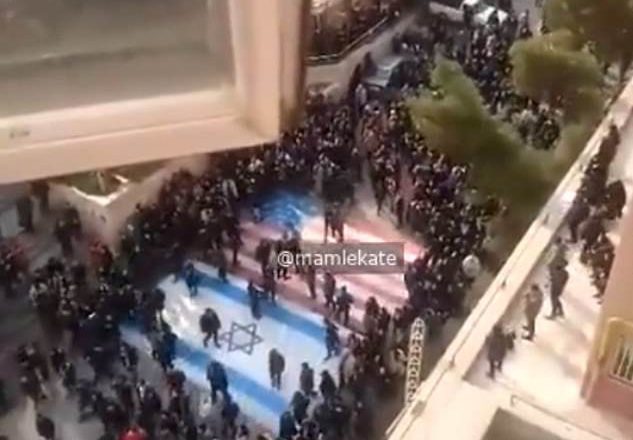 Emotional moment as Iranian students refuse to tread on US and Israeli flags during widespread anti-government demonstrations (video)