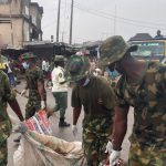 Soldiers clean Ogun market, clear drainage