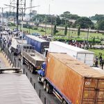 UNIBEN students protesting poor electricity barricade Benin-Ore highway